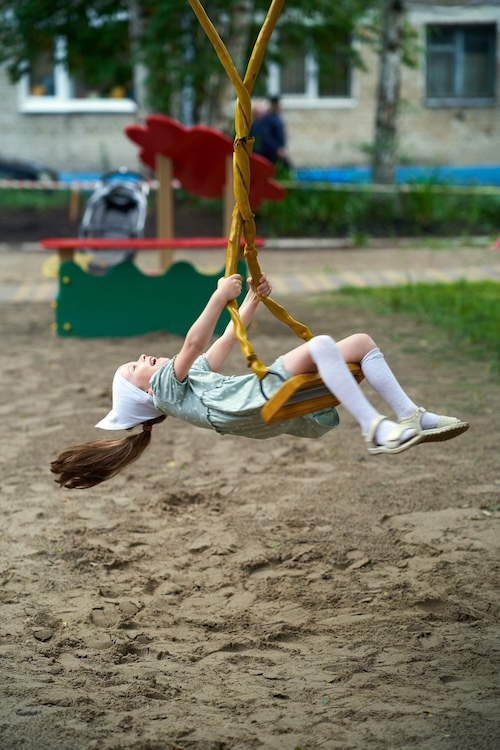A child playing on a swing